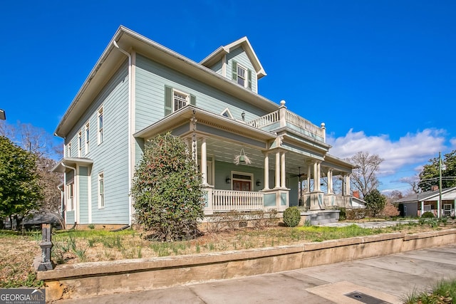 view of front of house with a porch and a balcony