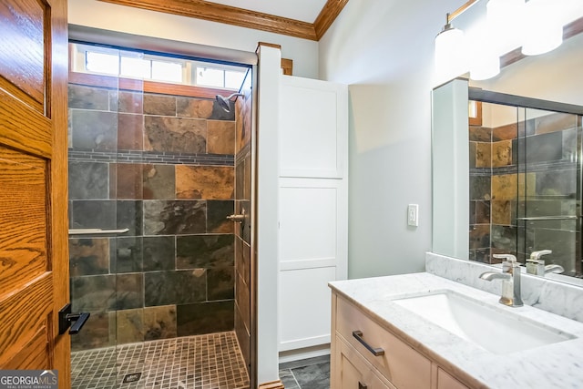 bathroom with a stall shower, vanity, and ornamental molding