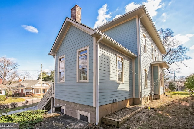 view of side of home with a chimney