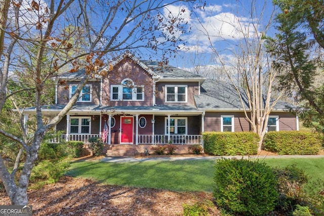 view of front of home with a porch and a front yard