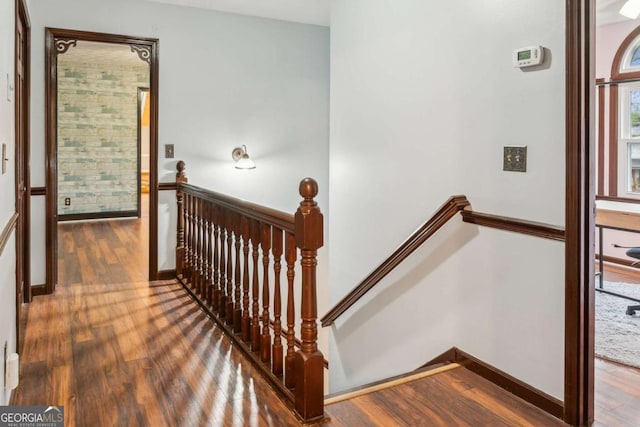 stairway with baseboards and wood finished floors