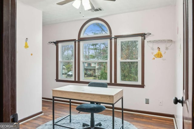 office space with ceiling fan, visible vents, baseboards, and wood finished floors