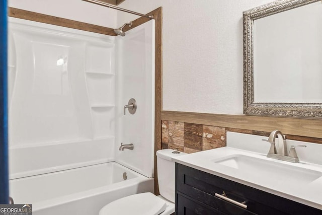 full bathroom with vanity, toilet, and washtub / shower combination