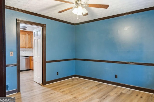 empty room featuring a ceiling fan, crown molding, light wood-style floors, and a textured ceiling