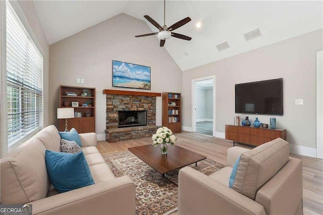 living area featuring visible vents, light wood-style flooring, high vaulted ceiling, and ceiling fan