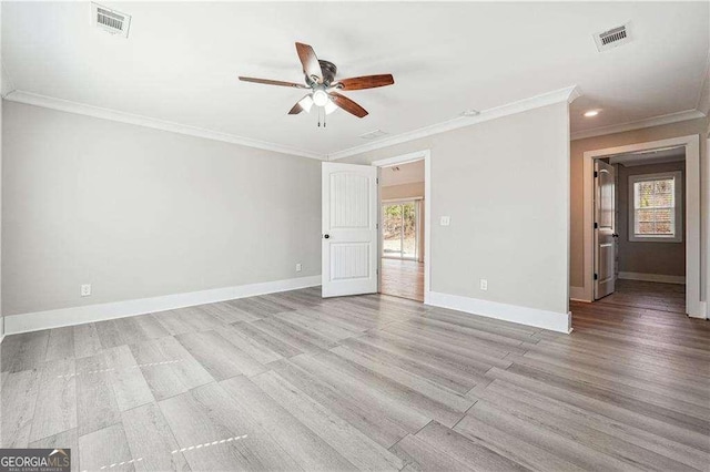 empty room featuring visible vents, light wood-style flooring, a ceiling fan, and baseboards