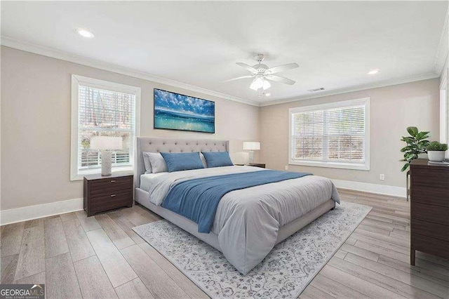 bedroom featuring visible vents, baseboards, ornamental molding, and light wood finished floors