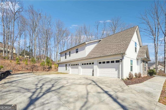 view of property exterior featuring concrete driveway and roof with shingles