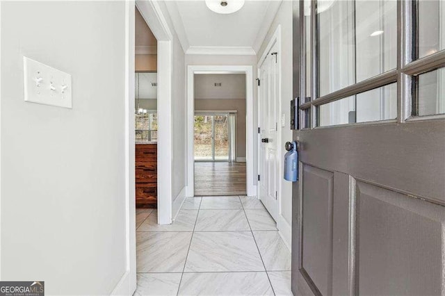 doorway with baseboards and ornamental molding