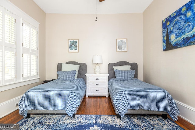 bedroom featuring wood finished floors and baseboards