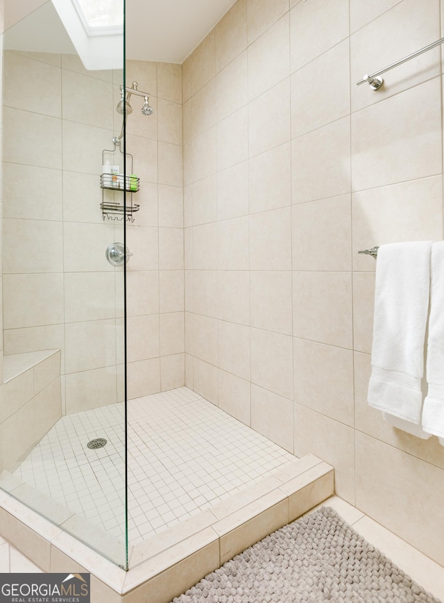 bathroom with tiled shower