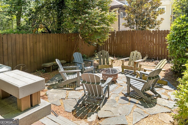 view of patio / terrace with a fire pit and fence