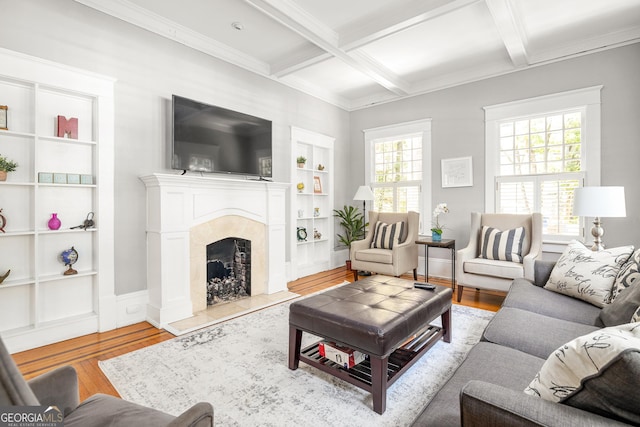 living room featuring a high end fireplace, baseboards, beamed ceiling, wood finished floors, and coffered ceiling