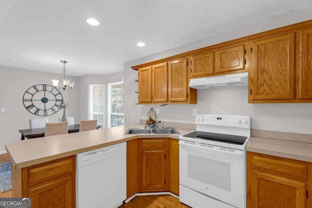 50 Riverside Ct, Hampton, GA 30228 - kitchen featuring white appliances, under cabinet range hood, a peninsula, light countertops, and recessed lighting