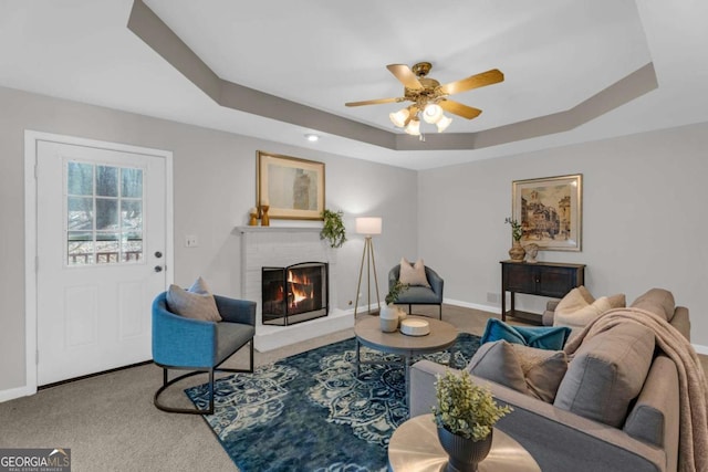 50 Riverside Ct, Hampton, GA 30228 - carpeted living room with a raised ceiling, a fireplace, and a ceiling fan