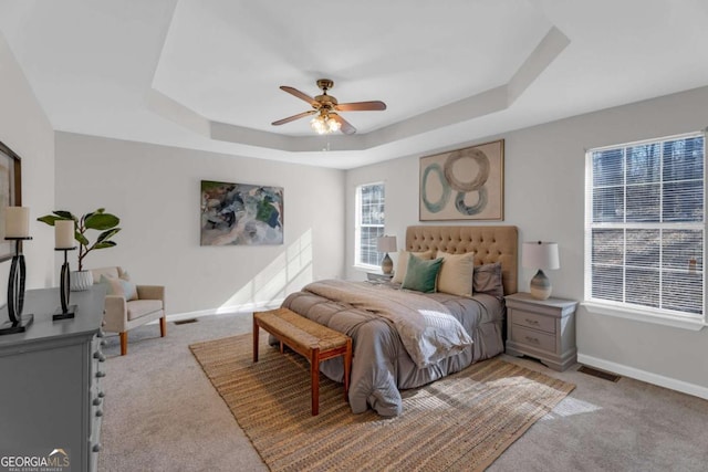 50 Riverside Ct, Hampton, GA 30228 - bedroom with light colored carpet, a tray ceiling, and ceiling fan