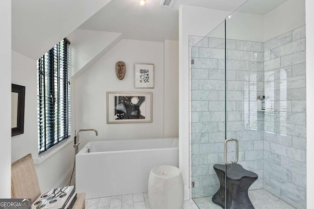 bathroom with visible vents, a shower stall, and a freestanding bath