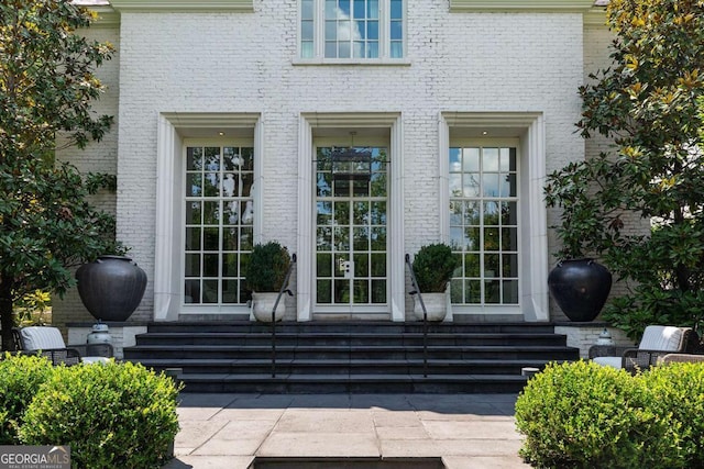 property entrance with brick siding