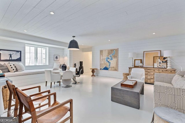 living room with recessed lighting and finished concrete floors