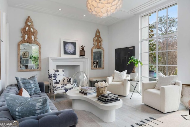 living room with recessed lighting, ornamental molding, and wood finished floors