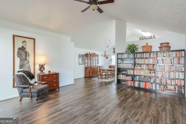 living area featuring a ceiling fan, vaulted ceiling, and wood finished floors