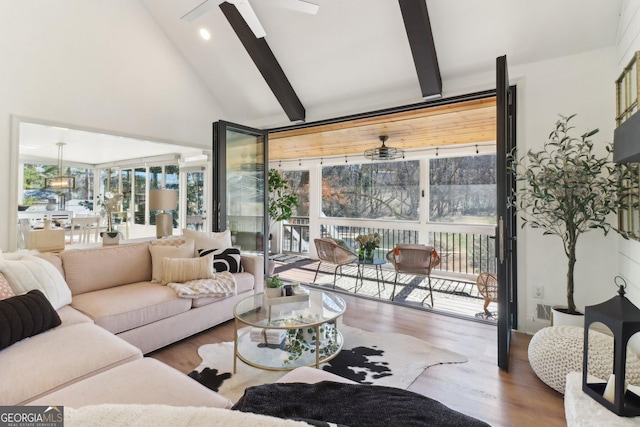 living area with beamed ceiling, floor to ceiling windows, wood finished floors, and a ceiling fan