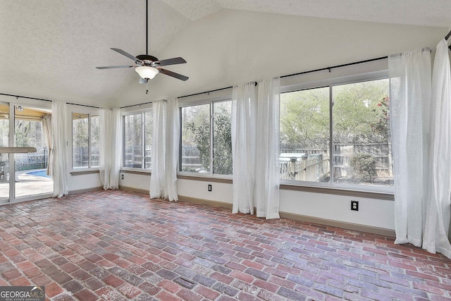 unfurnished sunroom featuring lofted ceiling and a ceiling fan