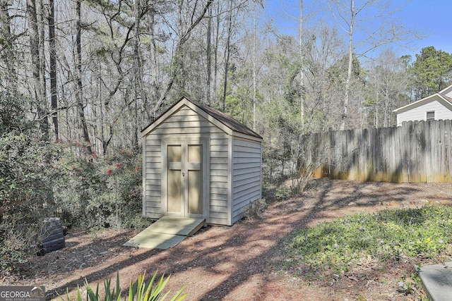 view of shed with fence