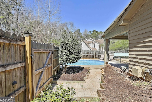 view of swimming pool featuring a patio area, a fenced in pool, and a fenced backyard