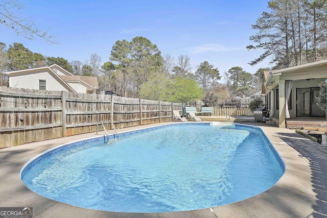 view of swimming pool featuring area for grilling, a fenced in pool, a patio, and a fenced backyard