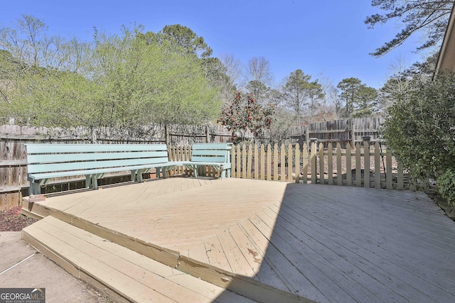 deck with a fenced backyard