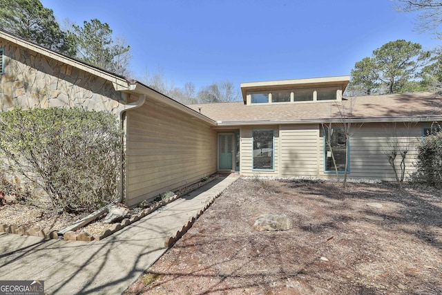 back of property with stone siding