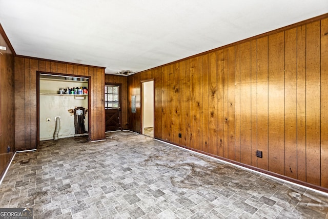 spare room with wood walls