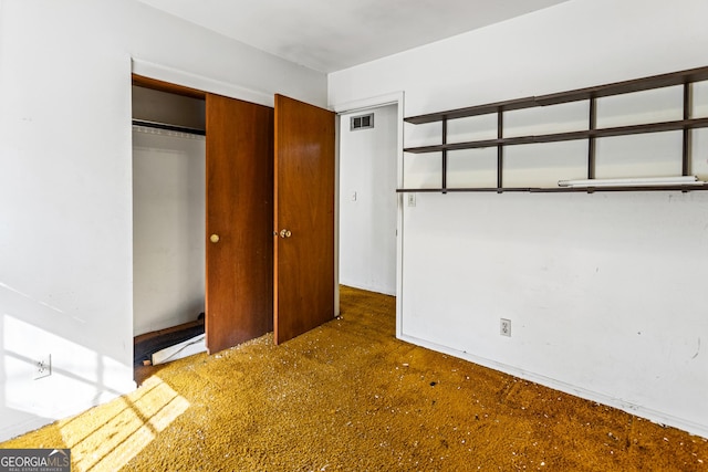 unfurnished bedroom featuring a closet and visible vents