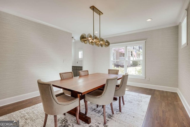 dining space with wallpapered walls, wood finished floors, and baseboards