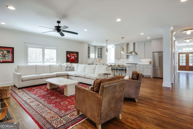 living room with recessed lighting, baseboards, dark wood finished floors, and ornate columns