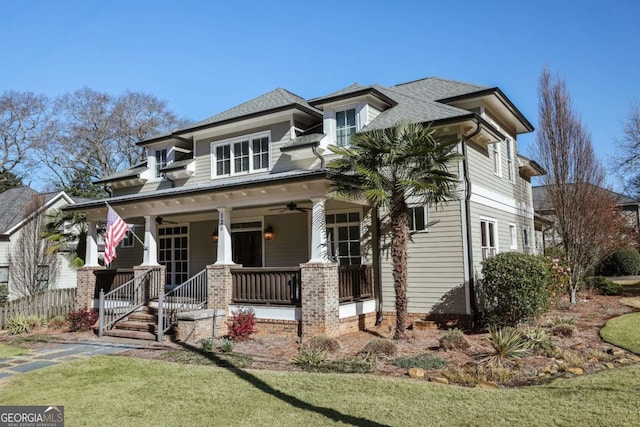 view of front of property featuring covered porch, a front yard, ceiling fan, and roof with shingles