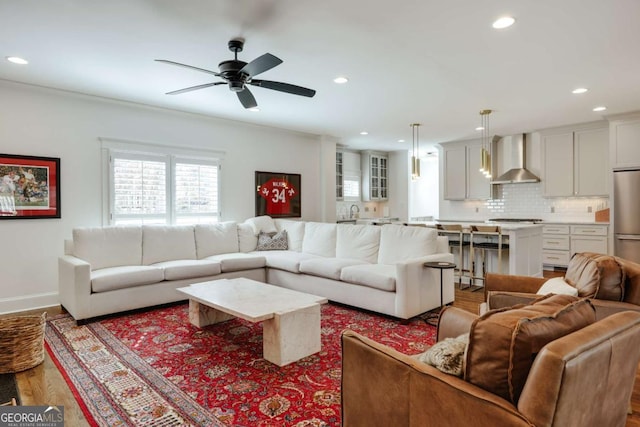 living area featuring recessed lighting, baseboards, wood finished floors, and ceiling fan