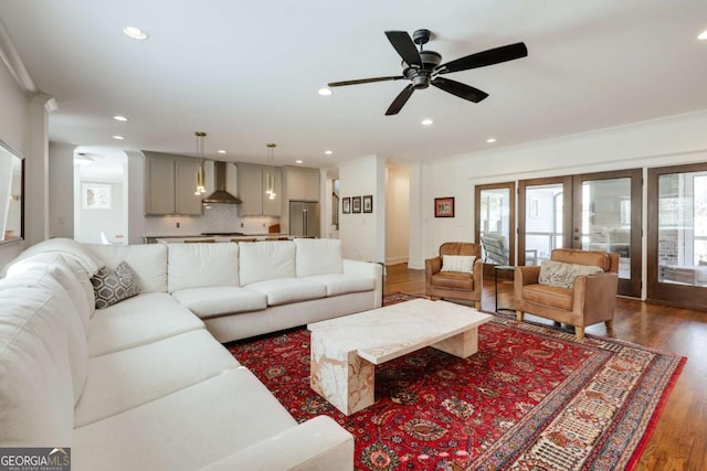 living area with dark wood-type flooring, crown molding, recessed lighting, and french doors