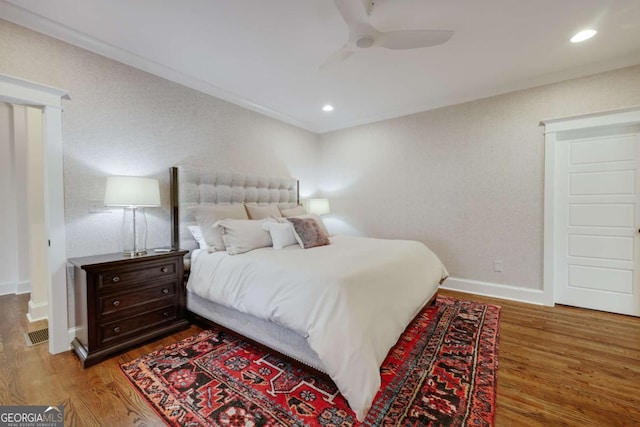 bedroom featuring recessed lighting, ornamental molding, baseboards, and wood finished floors