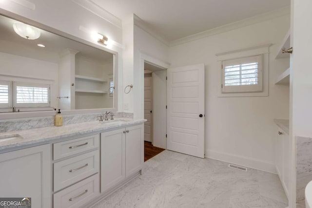 full bathroom with crown molding, double vanity, visible vents, and a sink