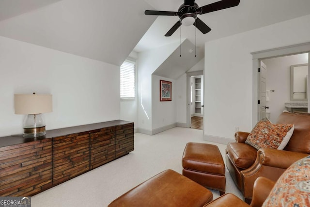 living area featuring carpet flooring, ceiling fan, baseboards, and lofted ceiling