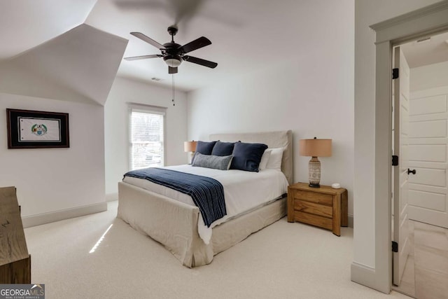 carpeted bedroom with ceiling fan and baseboards