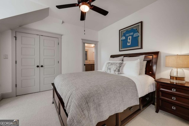 bedroom featuring a closet, light colored carpet, and ceiling fan