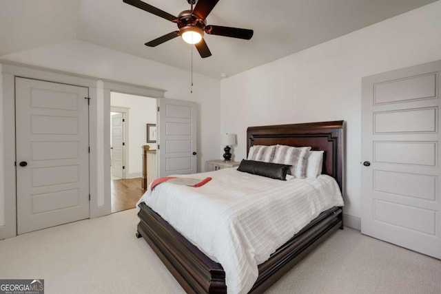 bedroom with light carpet, lofted ceiling, and a ceiling fan