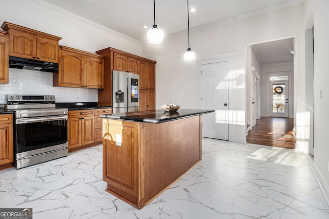 kitchen featuring marble finish floor, under cabinet range hood, tasteful backsplash, dark countertops, and stainless steel appliances