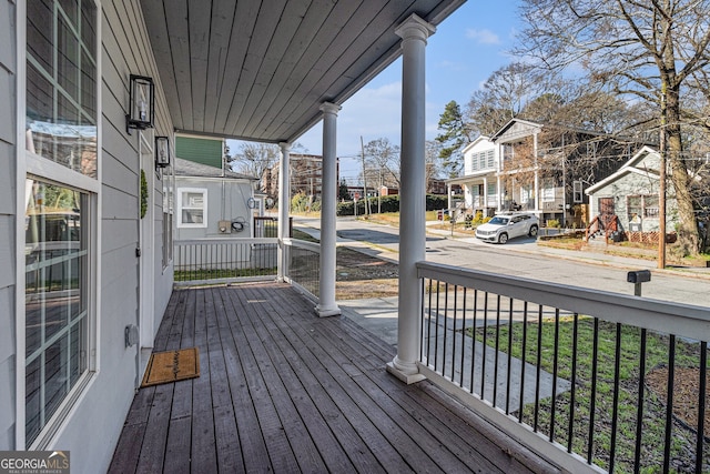 wooden deck with a porch and a residential view
