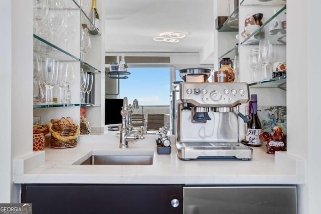 kitchen featuring beverage cooler, light countertops, and a sink