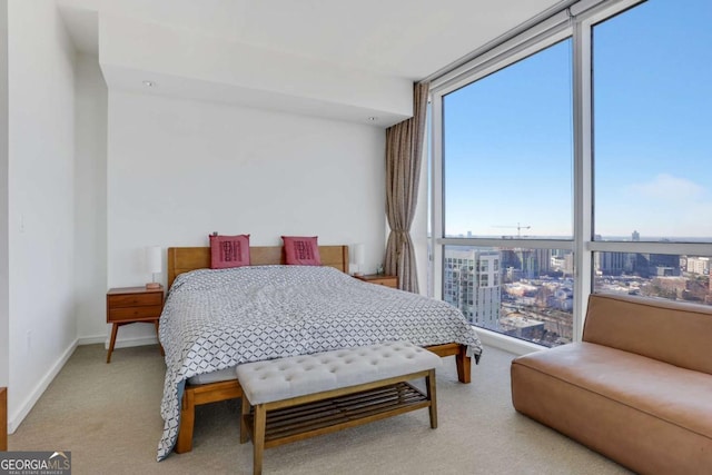 carpeted bedroom with floor to ceiling windows and baseboards