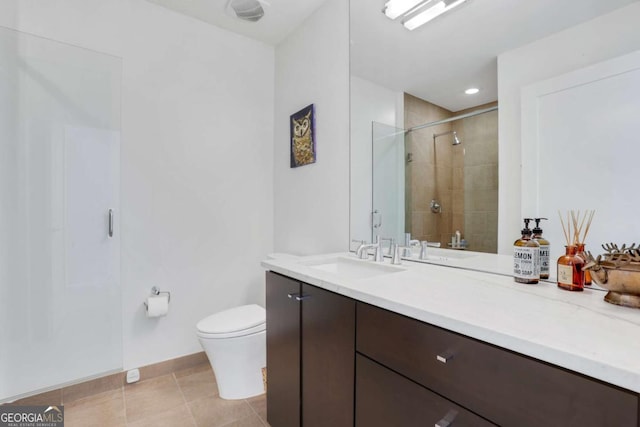 full bath featuring vanity, baseboards, a shower stall, tile patterned floors, and toilet